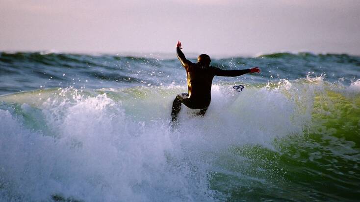 Someone surfing a wave in Seaside, Oregon