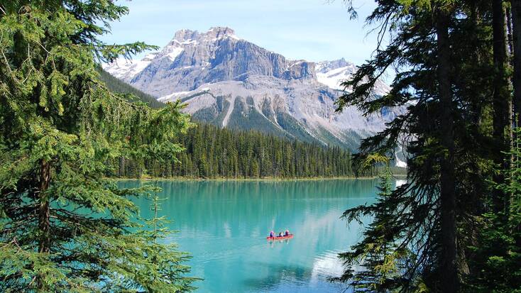 A view of Emerald Lake, BC, with visitors hiking during their vacations in Canada