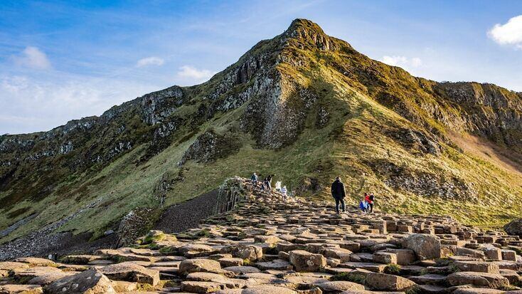 People exploring the rock formations of Giant's Causeway