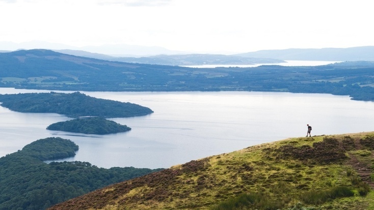 A hiker enjoying the views of Loch Lomond during the spring bank holiday