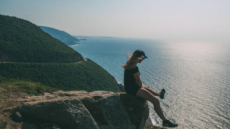 A hiker enjoying views from Cape Breton, Nova Scotia during a weekend getaway