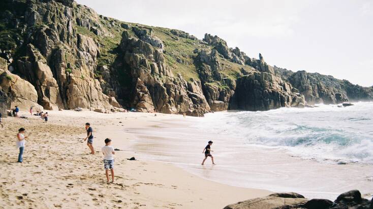 A family playing on a beach in Penzance, Cornwall, during the spring bank holiday