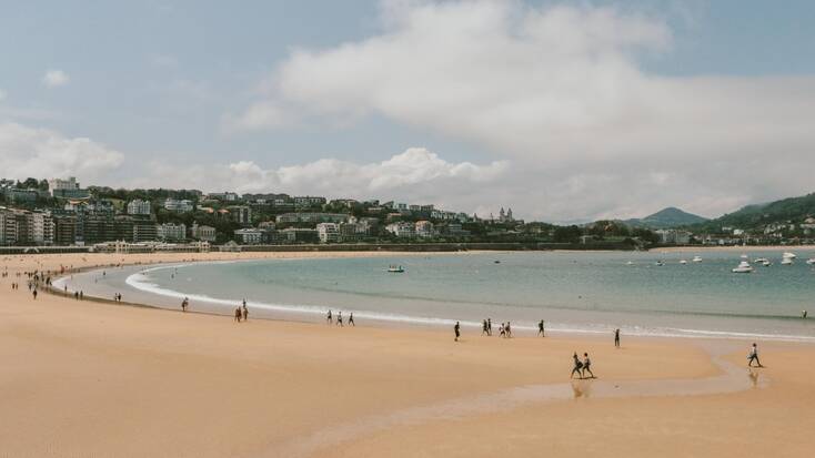 The beach in San Sebastian with holiday makers relaxing