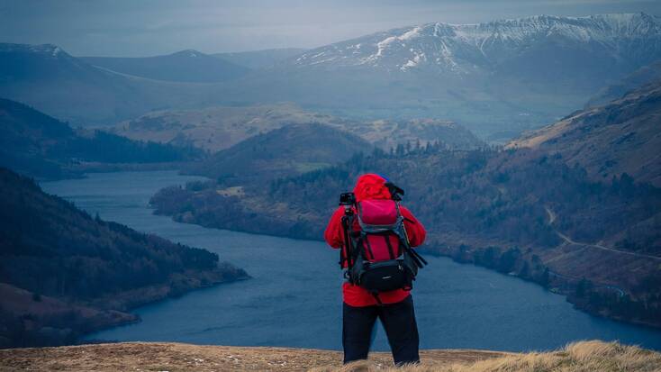 A hiker looking over the views of Steel Fell, Keswick, Cumbria