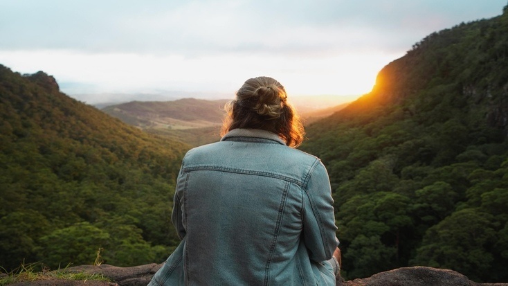 A visitor enjoying a stunning sunset over the Lamington National Park, Queensland during Queen's Birthday Weekend