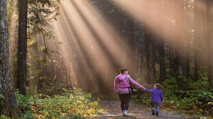 A mother and daughter walking in the woods, for things to do for Mothers Day