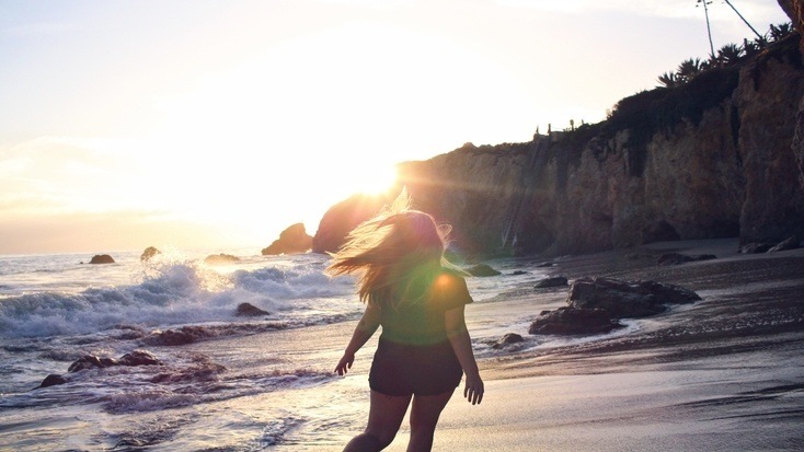 A girl enjoying the best beach vacations in Florida