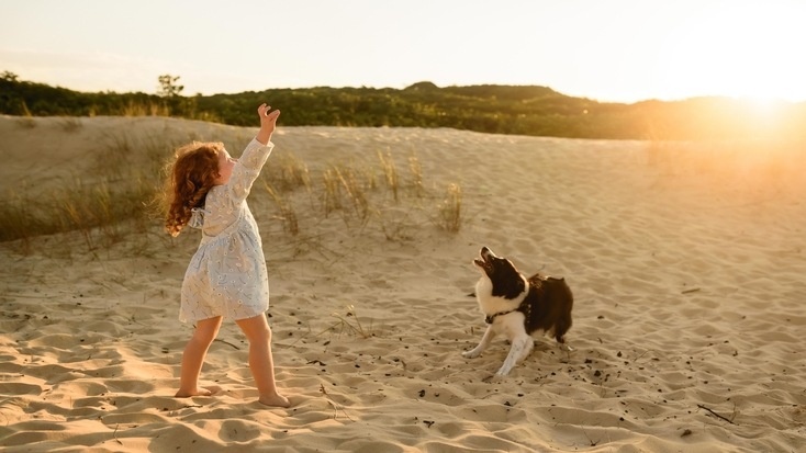 A girl and her dog at one of the beaches that allow dogs