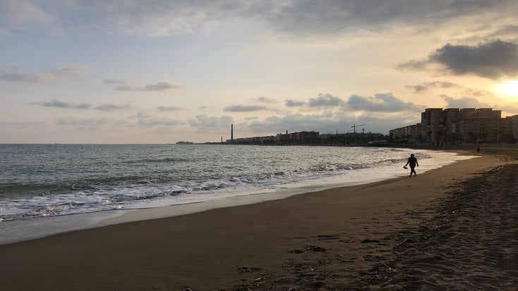A man walks alongside one of the beaches in Malaga