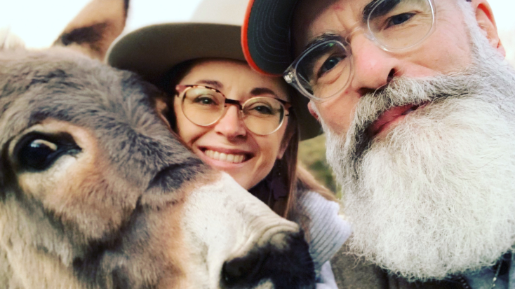 Host of the Month September 2021 - Sherry and Houston smiling with their donkey. 