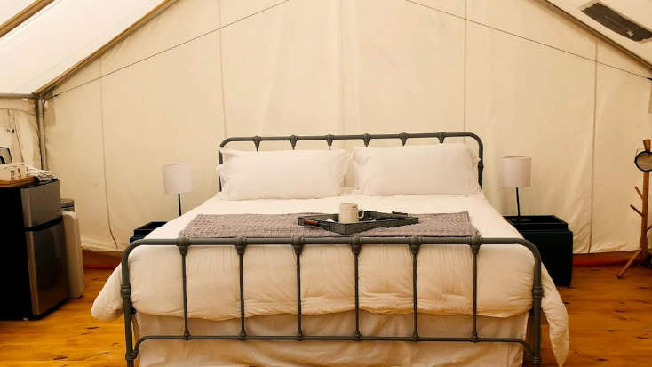 Luxury Queen Bed inside glamping tent in Texas