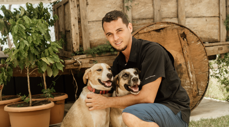 Team member at Glamping Hub's Host of the Month for March 2022 with two dogs.