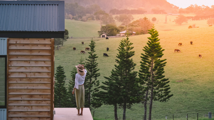 Guest enjoying the beautiful green landscape at an off season tiny house in Australia 