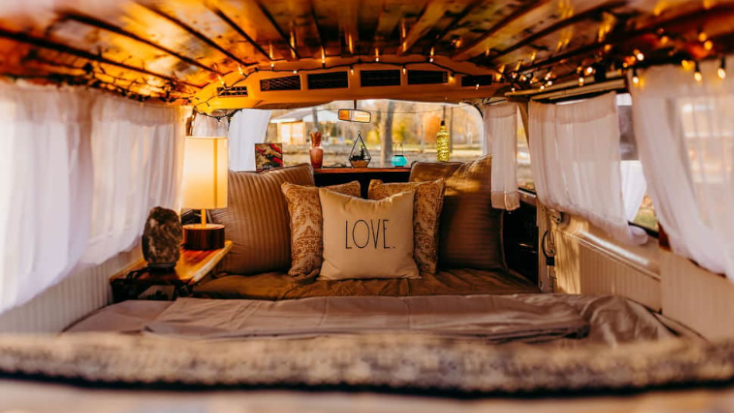 Cozy bed inside glamping campervan in Missouri
