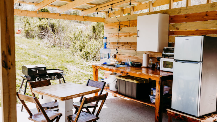 Shared outdoor kitchen with grill at unique glamping and wedding venue in Missouri