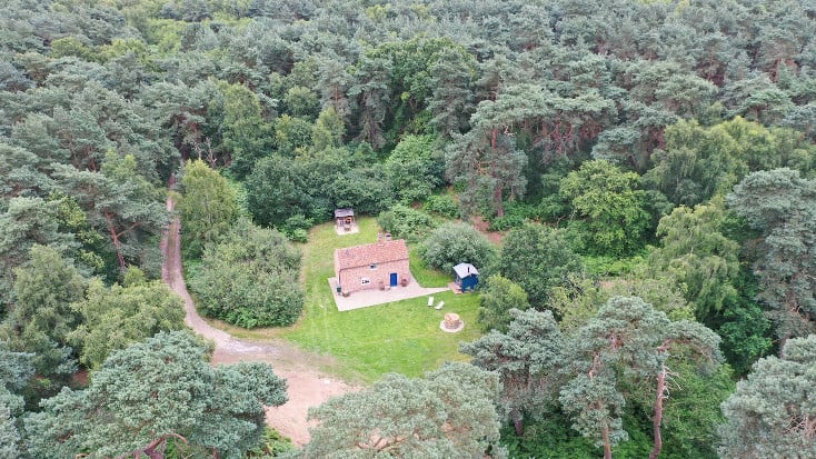 Secluded cottage surrounded by woods in England