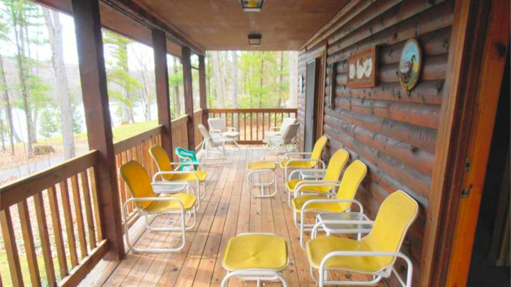 Cabin deck with yellow seating and lake view in Maryland
