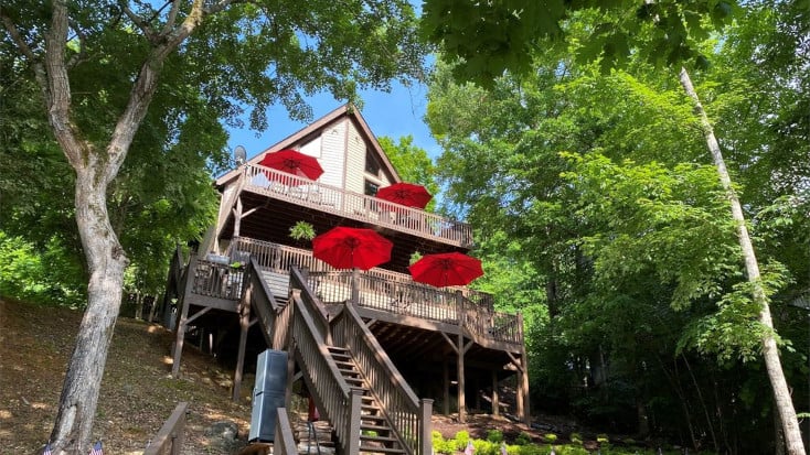 Large lakefront cabin with multiple decks on Lake Norris, Tennessee is our pick as one of the best lake house vacations