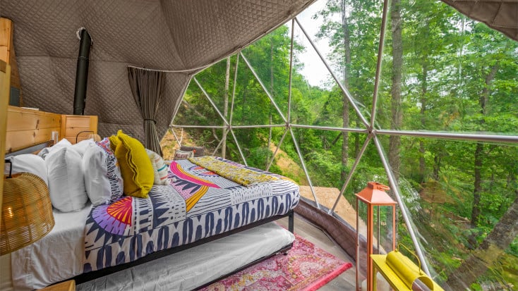 Interior dome with forest views and brightly colored bedding
