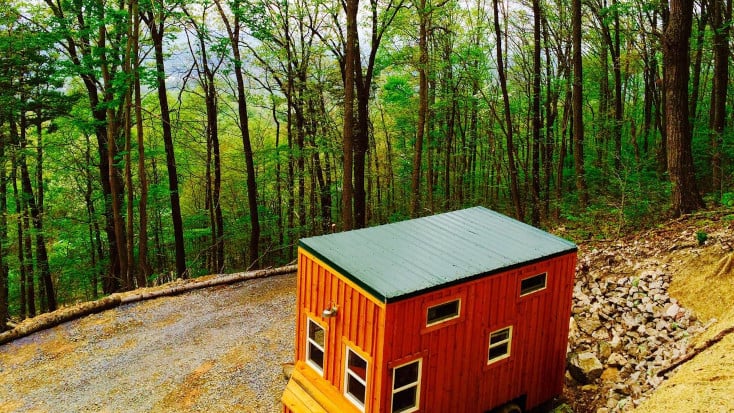 Secluded tiny house or cabin surrounded by woodlands