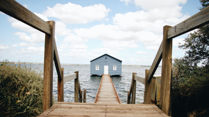 Blue tiny house on secluded island with private walkway