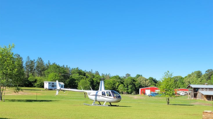 Guests arriving by helicopter to Host of the Month for May 2023, Denise and To'm tiny hose glamping site!