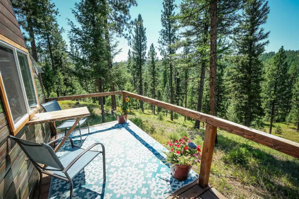 private deck with view of the pine forest in Bonner Montana for a glamping getaway
