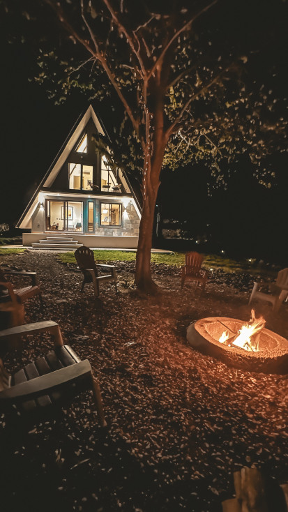 A-frame at night with fire pit