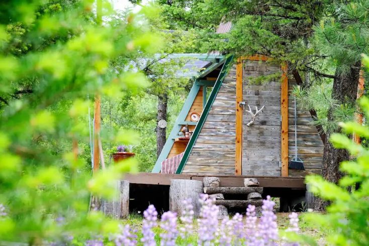 A-frame cabin surrounded by pine forests in Bonner, Montana